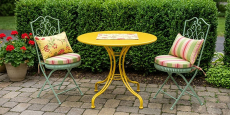 Round Duralee Royal Palm Kiwi Pink seat cushions with ties on an outdoor bistro set