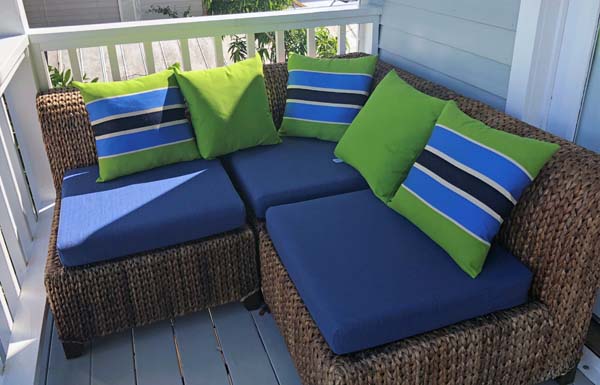 Bright Pillows Pop Against Sunbrella RAIN Loveseat Cushions