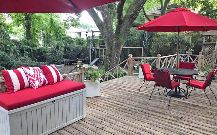 Bold Cherry Red Patio Accents Pop on Rustic Deck
