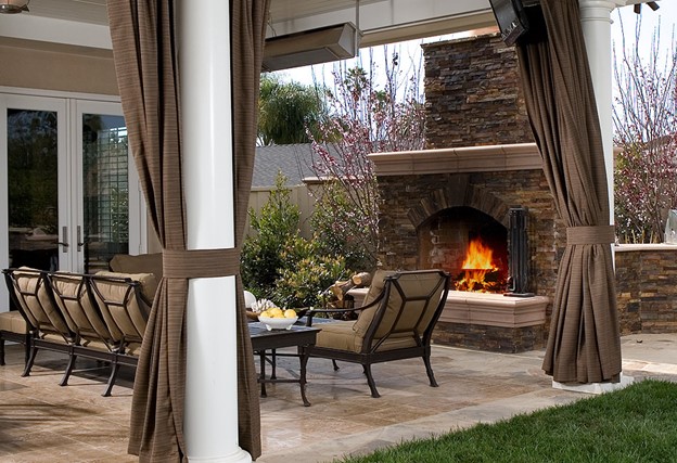 Create an insulated outdoor patio with Sunbrella curtains
